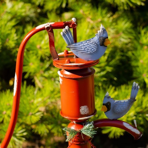 Old Style Red Iron Water Pump with "Merry Christmas" Sign and Birds